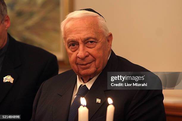 Israeli Prime minister Ariel Sharon is seen as he takes part in the lighting of the second Hanukkah candle, at his Jerusalem office Monday Dec. 26,...