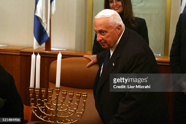 Israeli Prime minister Ariel Sharon is seen as he takes part in the lighting of the second Hanukkah candle, at his Jerusalem office Monday Dec. 26,...