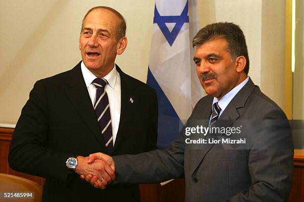 Turkish Foreign Minister Abdullah Gul shakes hands with Israeli Prime Minister Ehud Olmert after their meeting in Jerusalem on Sunday Aug. 20 2006.
