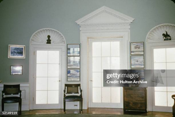 Interior view of the Harry S. Truman Presidential Museum and Library shows a Presidential seal as well as a number of framed pictures of airplanes,...