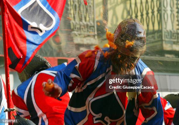 Member of a cart team is seen during the "Orange Battle" at the 2005 Ivrea Carnival on February 6, 2005 in Ivrea, Italy. During the "Orange Battle"...