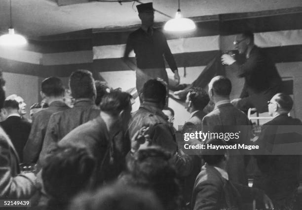 Players, fans and former players of Bath Rugby Football Club singing enjoy a drink and a song, 7th December 1946. Original publication: Picture Post...