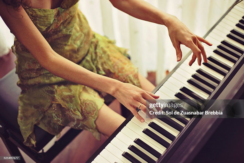 Woman with nice dress playing the piano