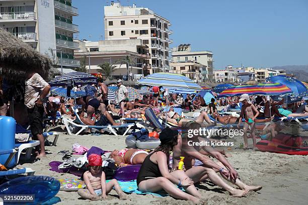 extremely crowded balearic beach - crowded beach stock pictures, royalty-free photos & images