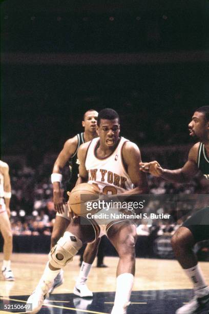 Bernard King of the New York Knicks looks to make a move in the paint against the Milwaukee Bucks during an NBA game in 1986 at Madison Square Garden...