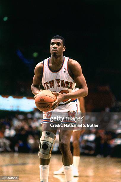 Bernard King of the New York Knicks shoots a free throw against the Milwaukee Bucks during an NBA game in 1986 at Madison Square Garden in New York,...