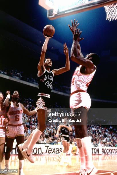 George Gervin of the San Antonio Spurs shoots a running one handed jump shot against the Houston Rockets during an NBA game in1984 at the Summit in...
