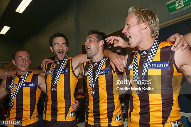 Billy Hartung, Jordan Lewis, Luke Hodge and Will Langford of the Hawks sing the song in the rooms after winning during the round four AFL match...