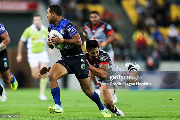 Moses Mbye of the Bulldogs is tackled by Shaun Johnson of the Warriors during the round seven NRL match between the Canterbury Bulldogs and the New...