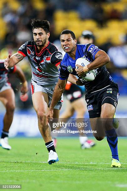 Moses Mbye of the Bulldogs is tackled by Shaun Johnson of the Warriors during the round seven NRL match between the Canterbury Bulldogs and the New...