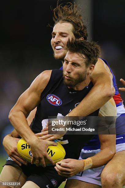 Dale Thomas of the Blues is tackled by Marcus Bontempelli of the Bulldogs during AFL Round 4 match between the Carlton Blues and the Western Bulldogs...