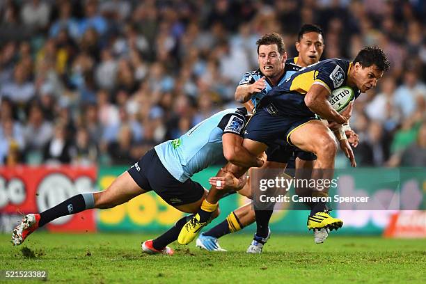 Matt Toomua of the Brumbies is tackled during the round eight Super Rugby match between the Waratahs and the Brumbies at Allianz Stadium on April 16,...