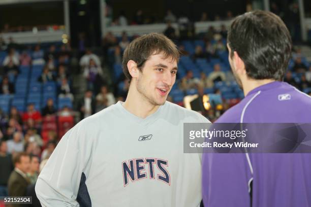 Nenad Krstic of the New Jersey Nets speaks with fellow Serbia-Montenegro native Peja Stojakovic of the Sacramento Kings January 25, 2005 at Arco...