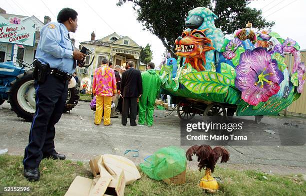 Revelers inspect a broken-down float during the historic Proteus parade, founded in 1882, during Mardi Gras festivites February 7, 2005 in New...