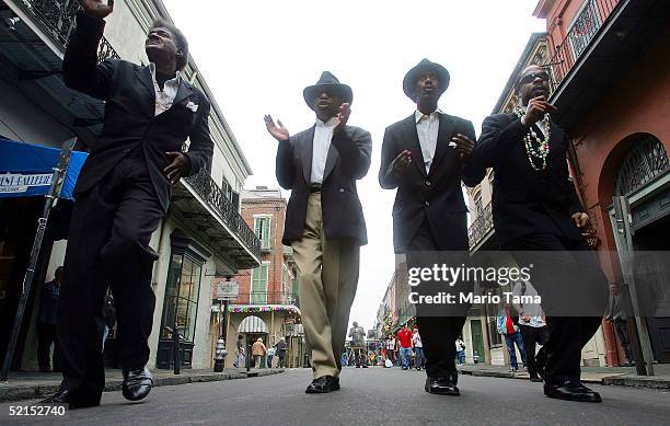 African-American men sing on the street during Mardi Gras festivites February 7, 2005 in New Orleans, Louisiana. Festivities will continue all...