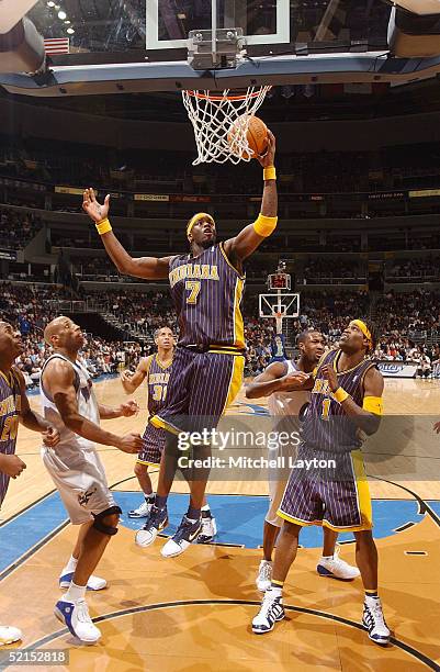 Jermaine O'Neal of the Indiana Pacers pulls down a rebound in a game against the Washington Wizards on February 7, 2005 at the MCI Center in...