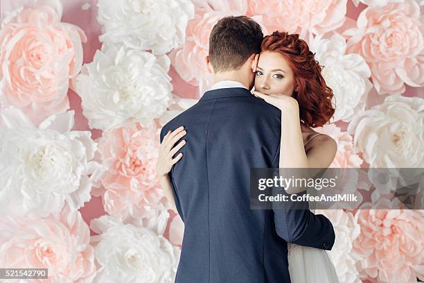 studio shot of two young beautiful people - giant roses stock pictures, royalty-free photos & images