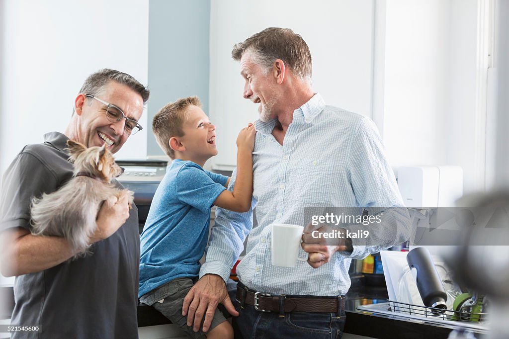Alternative lifestyle, two fathers and son in kitchen