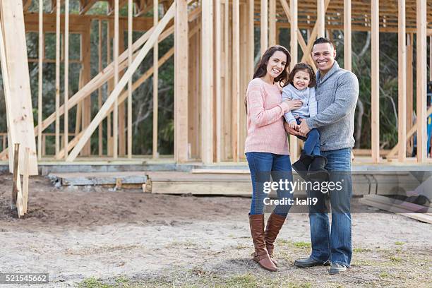 hispanic family building a new home - couple full length stock pictures, royalty-free photos & images