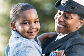 Mother in navy officer uniform holding son