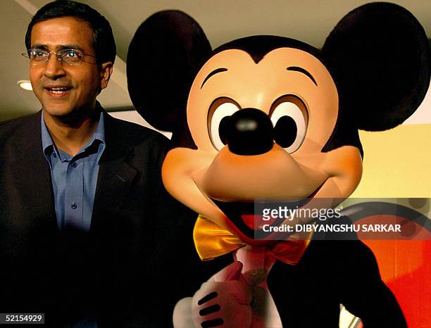 Managing Director of Walt Disney Television International Rajat Jain poses with 'Mickey Mouse' during a press conference in Madras 08 February 2005,...