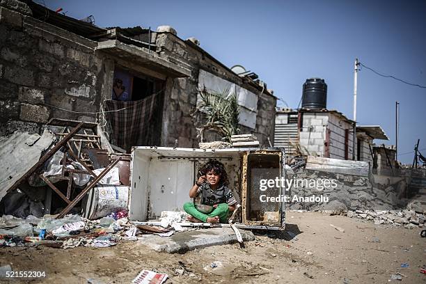 Refugee girl eats food on street at Khan Yunis refugee camp, in Khan Yunis, Gaza on April 16, 2016. Khan Yunis Camp was established after the 1948...