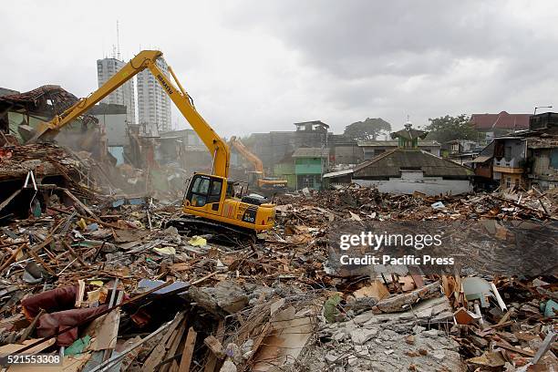 Officials use a bulldozer to demolish buildings at Kalijodo red-light district. Bulldozers started demolishing hundreds of buildings in the...
