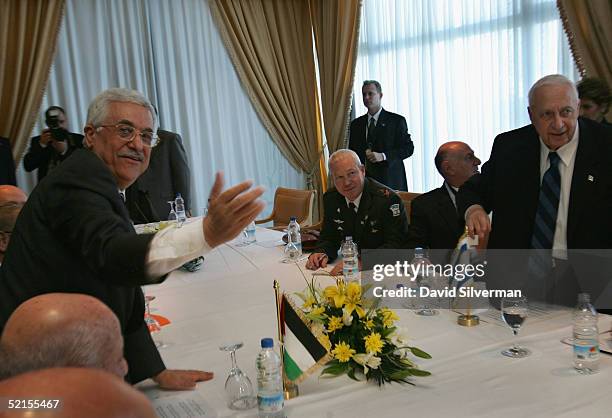 Palestinian President Mahmoud Abbas and Israeli Prime Minister Ariel Sharon stand at the start of their bilateral meeting at the peace summit...