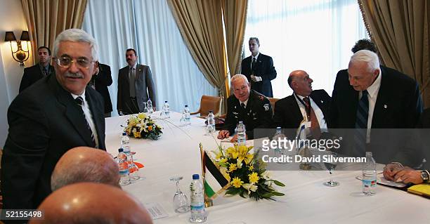 Palestinian President Mahmoud Abbas and Israeli Prime Minister Ariel Sharon take their seats at the start of the bilateral meeting at the peace...