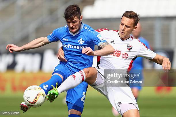 Marcel Heller of Darmstadt is challenged by Robert Bauer of Ingolstadt during the Bundesliga match between SV Darmstadt 98 and FC Ingolstadt at...