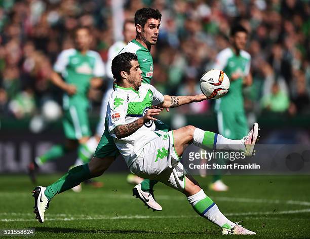 Fin Bartels of Bremen is challenged by Vierinha of Wolfsburg during the Bundesliga match between Werder Bremen and VfL Wolfsburg at Weserstadion on...