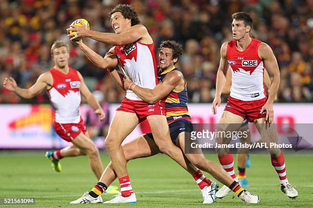 Kurt Tippett of the Swans is tackled by Kyle Hartigan of the Crows during the 2016 AFL Round 04 match between the Adelaide Crows and the Sydney Swans...