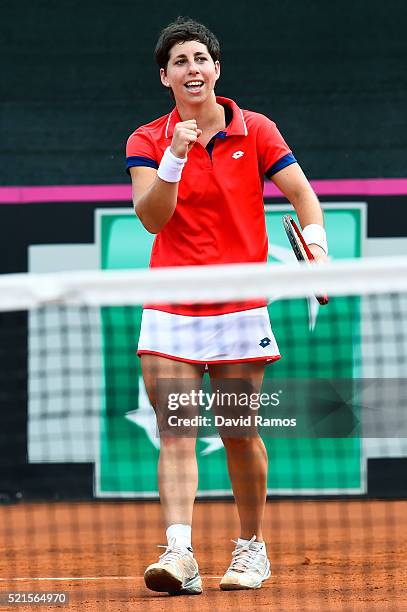 Carla Suarez Navarro of Spain celebrates defeating Roberta Vinci of Italy during day one of the Fed Cup World Group Play-off Round match between...