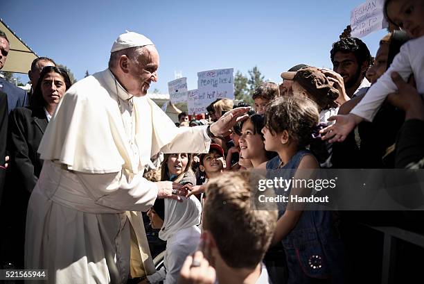 In this handout image provided by Greek Prime Minister's Office, Pope Francis meets migrants at the Moria detention centre on April 16, 2016 in...