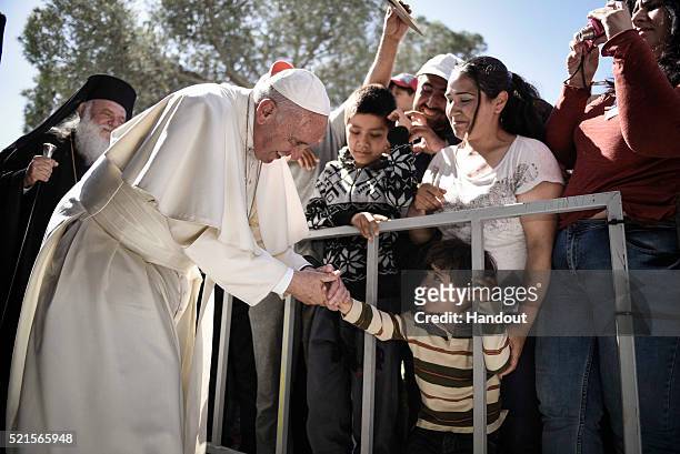 In this handout image provided by Greek Prime Minister's Office, Pope Francis meets migrants at the Moria detention centre on April 16, 2016 in...