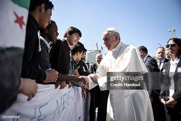 In this handout image provided by Greek Prime Minister's Office, Pope Francis meets migrants at the Moria detention centre on April 16, 2016 in...