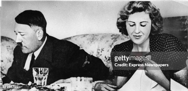 German dictator Adolf Hitler and his mistress Eva Braun dine in a still from a private home movie made by Braun's sister Gretl Fegelein, early to mid...