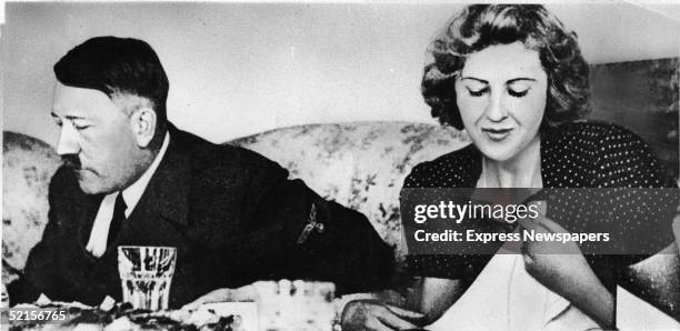 German dictator Adolf Hitler and his mistress Eva Braun dine in a still from a private home movie made by Braun's sister Gretl Fegelein, early to mid...