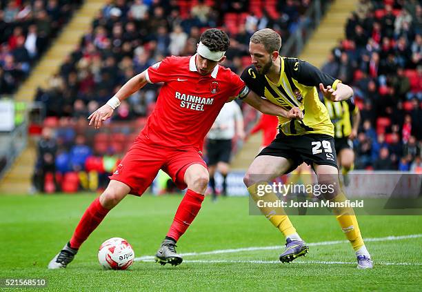 Mathieu Baudry of Leyton Orient tackles with Luke Pennell of Dagenham & Redbridge during the Sky Bet League Two match between Leyton Orient and...