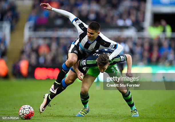 Aleksandar Mitrovic of Newcastle United makes a challenge on Federico Fernandez of Swansea City during the Barclays Premier League match between...