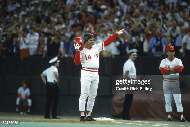 Pete Rose of the Cincinnati Reds points to the stands in victory on scoring his 4192 hit off of pitcher Eric Show, breaking Ty Cobb's record during a...