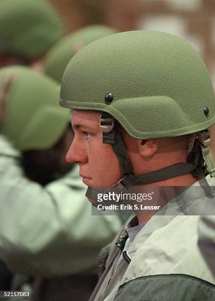 Army soldier with the Georgia National Guard's 48th Infantry Brigade trys on his Advanced Combat Helmet while being issued the U.S. Army's new Army...