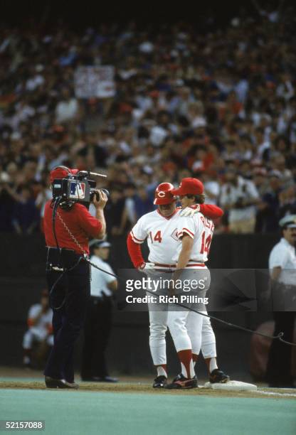 Pete Rose of the Cincinnati Reds stands with his son Pete Rose Jr in front of a cameraman to celebrate the victory on scoring his 4192 hit off of...