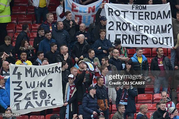 Aston Villa fans hold up banners referencing their 1982 European Cup victory in Rotterdam and their possible relegation to the Championship where...