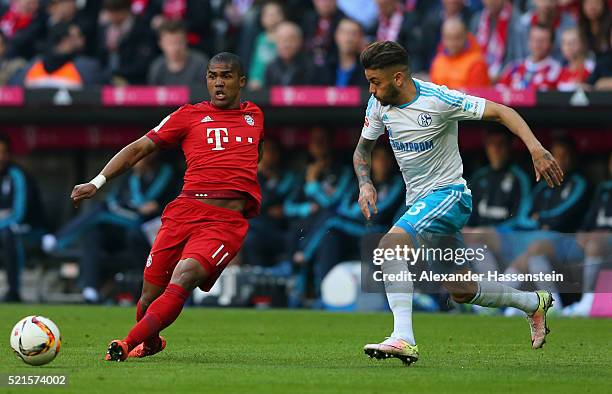 Douglas Costa of Bayern Muenchen is chased down by Uilson de Souza Paula Junior of Schalke during the Bundesliga match between FC Bayern Muenchen and...