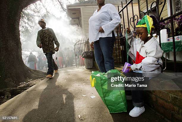 Girl gathers her beads during the Zulu parade, a primarily African-American parade, during Mardi Gras festivities February 8, 2005 in New Orleans,...