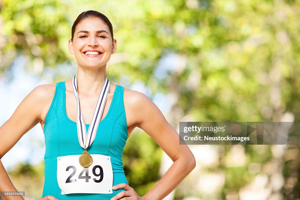 Portrait Of Happy Marathon Gold Medalist At Park