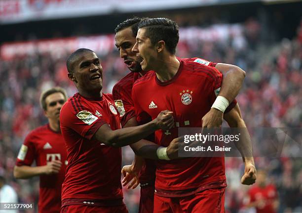 Robert Lewandowski of Bayern Muenchen celebrates his first goal together with teammates Douglas Costa and Medhi Benatia during the Bundesliga match...