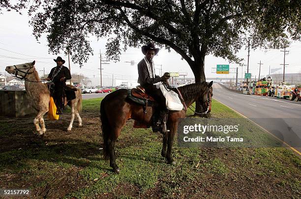 Riders on horeback wait to join the Zulu parade, a primarily African-American parade, during Mardi Gras festivities February 8, 2005 in New Orleans,...