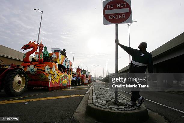 Man watches as floats before it joins the Zulu parade, a primarily African-American parade, during Mardi Gras festivities February 8, 2005 in New...